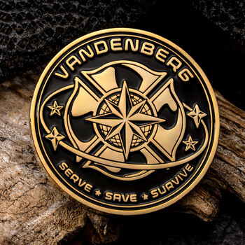 Gold and black challenge coin featuring a firefighter Maltese cross, compass star, and text reading Vandenberg Serve Save Survive.